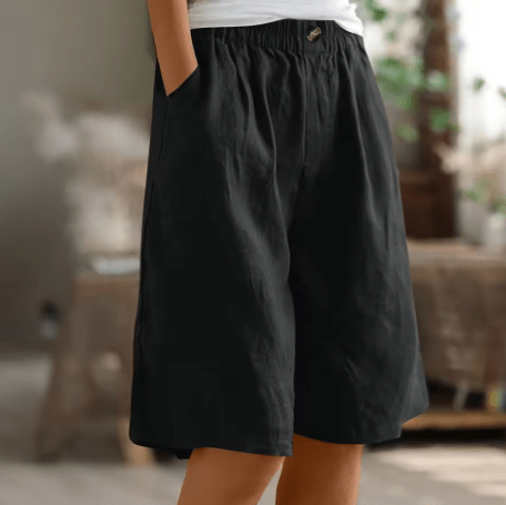 Pantalón corto de algodón negro, cintura elástica con botón, pierna recta y holgada